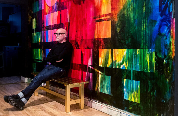 Robert Sangster sitting in front of the LONG LIVE PRINT Mural